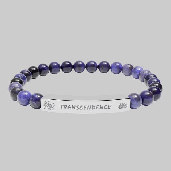Beaded bracelet with a silver tag saying Transcendence with galaxy and lotus symbols