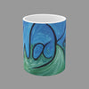 A white ceramic mug featuring an abstract, swirling painted design in shades of blue and green with black Awakening word in script.