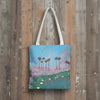 Tote bag with a print of palm tree and sunset painting with lily pads