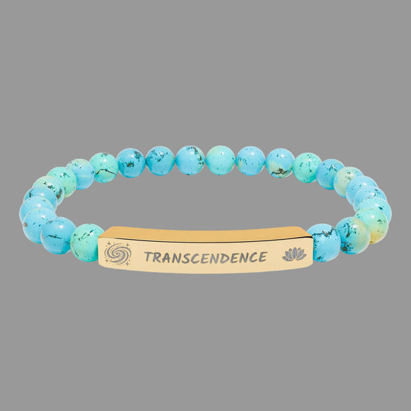Turquoise beaded bracelet with a gold tone tag saying Transcendence with galaxy spiral and lotus symbols