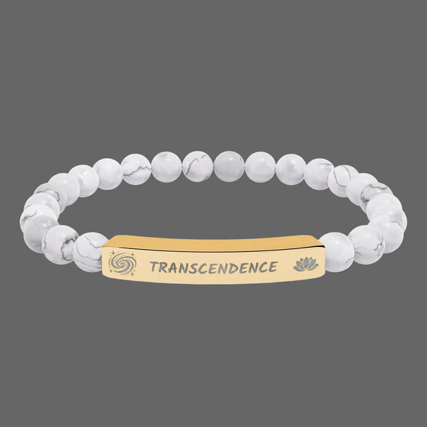 Beaded bracelet with a gold tone tag saying Transcendence with galaxy and lotus symbols